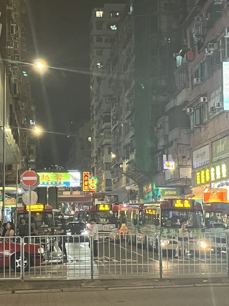 バスとネオンが行き交う夜の香港・旺角